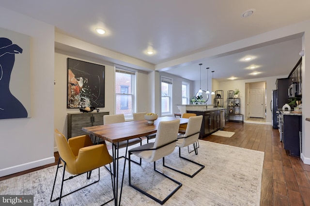 dining room with dark wood-type flooring and baseboards