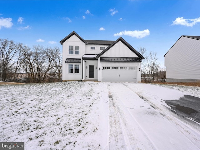 modern farmhouse with an attached garage, a standing seam roof, metal roof, and board and batten siding