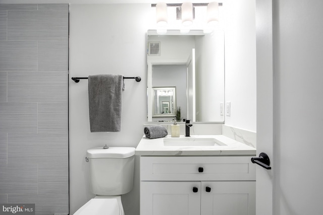 bathroom featuring visible vents, vanity, and toilet