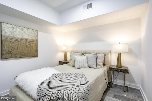 bedroom with dark wood-type flooring, visible vents, and baseboards