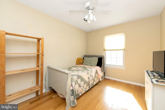 bedroom featuring ceiling fan, wood finished floors, and baseboards