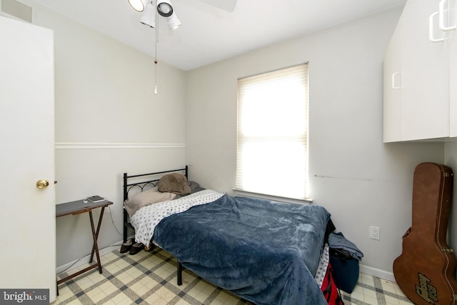 bedroom featuring a ceiling fan, visible vents, and baseboards