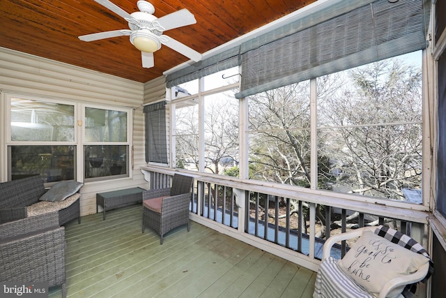 sunroom with wooden ceiling and ceiling fan