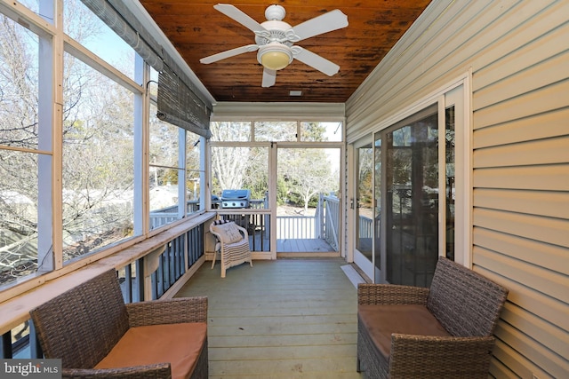 sunroom / solarium featuring wooden ceiling and a ceiling fan