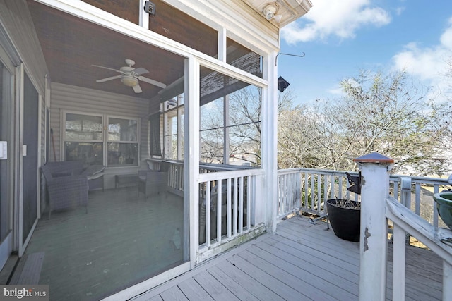 wooden terrace featuring a ceiling fan