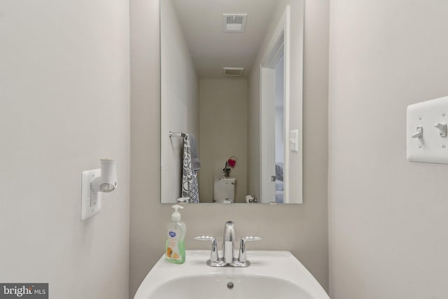 bathroom featuring visible vents and a sink