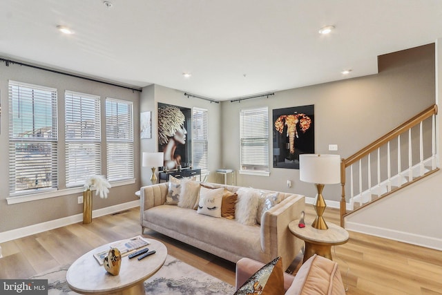 living area with baseboards, visible vents, stairway, wood finished floors, and recessed lighting