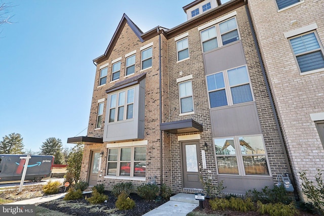 view of front of house featuring brick siding