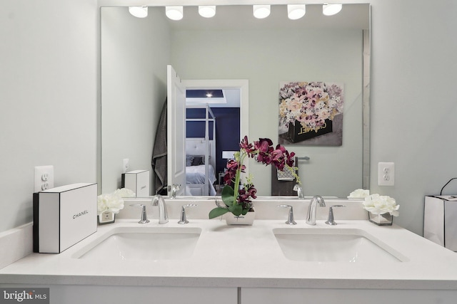 full bathroom featuring a sink, ensuite bath, and double vanity