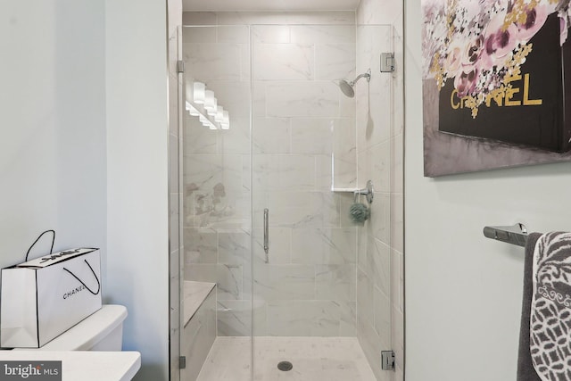 bathroom featuring a shower stall and toilet