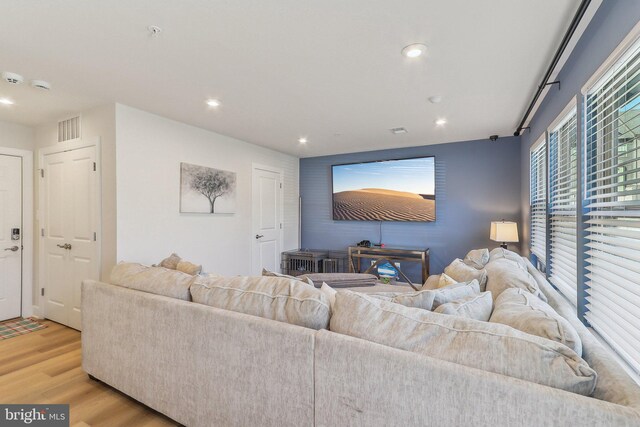 living area featuring light wood-style flooring, visible vents, and recessed lighting