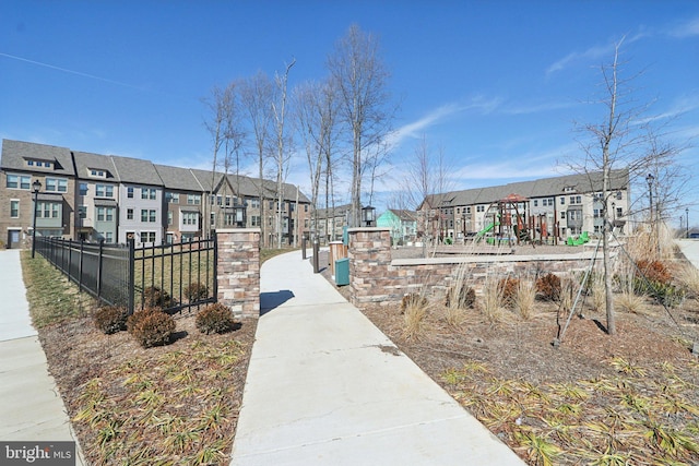 view of home's community with a residential view, fence, and playground community