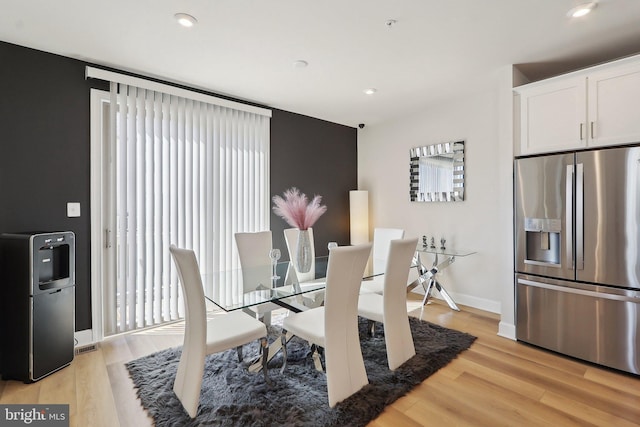 dining space featuring light wood-type flooring, baseboards, and recessed lighting