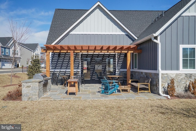 view of patio with exterior kitchen, grilling area, and a pergola