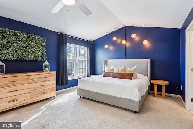 carpeted bedroom with vaulted ceiling, ceiling fan, and baseboards