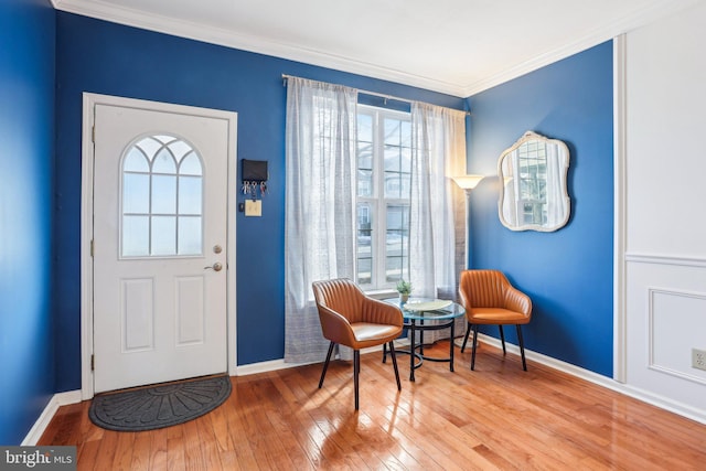 foyer entrance with baseboards, wood-type flooring, and crown molding