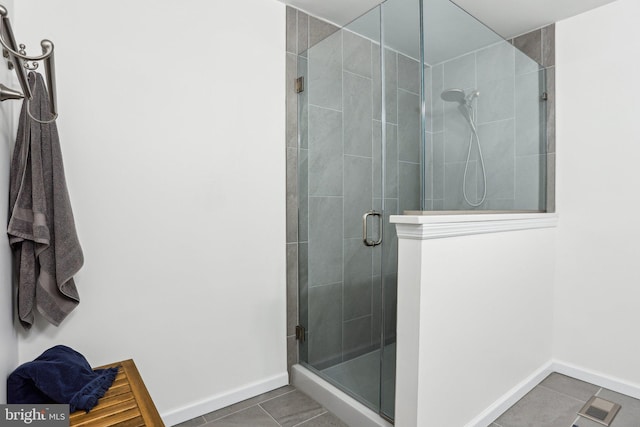 bathroom featuring a stall shower, tile patterned flooring, visible vents, and baseboards