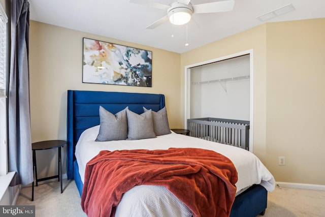 bedroom featuring carpet flooring, a ceiling fan, visible vents, baseboards, and a closet