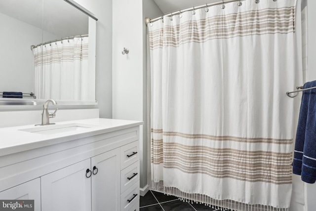 full bath featuring curtained shower, vanity, and tile patterned floors