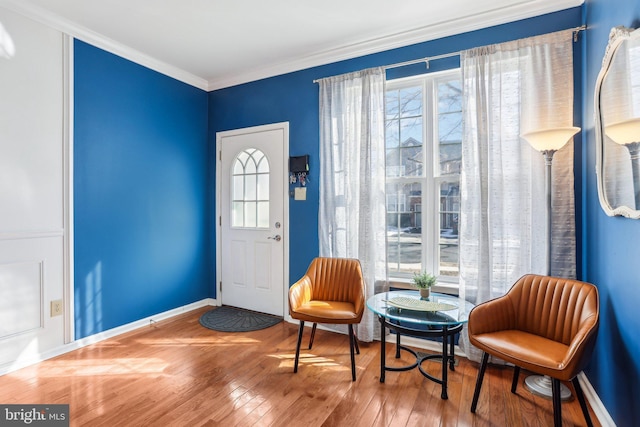 entrance foyer featuring crown molding, baseboards, and hardwood / wood-style floors