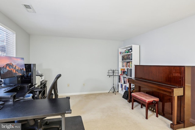 office space with visible vents, light carpet, and baseboards