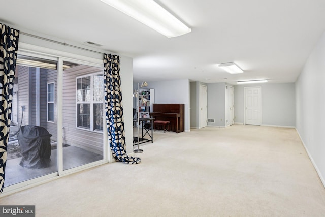 interior space with carpet floors, baseboards, and visible vents