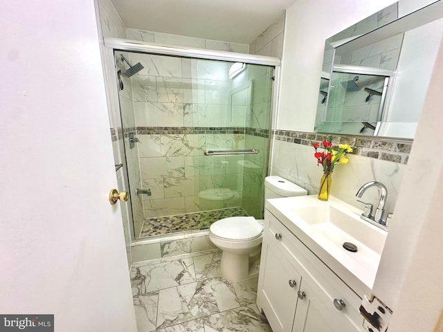 bathroom featuring toilet, marble finish floor, a shower stall, and vanity