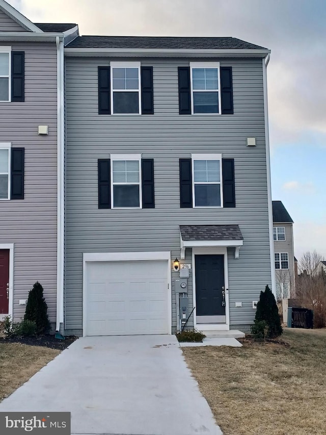 view of front of home with driveway, a front lawn, and an attached garage