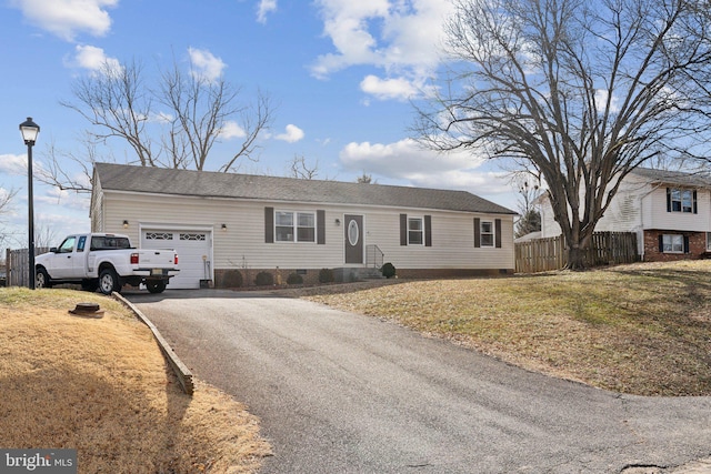 ranch-style home with crawl space, a garage, fence, and aphalt driveway