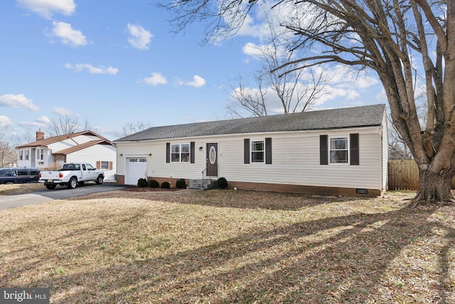 single story home with aphalt driveway, an attached garage, crawl space, fence, and a front lawn