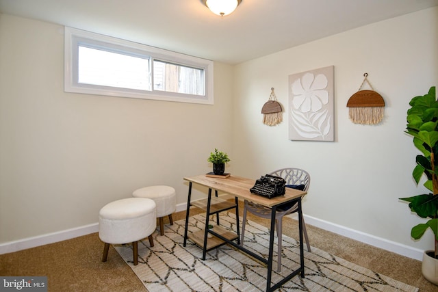 home office with baseboards and light colored carpet