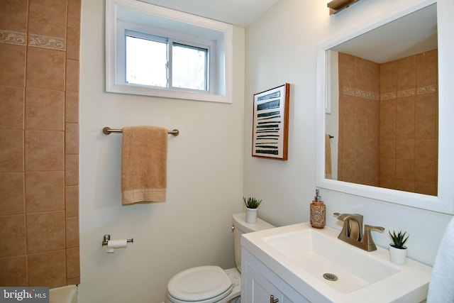 full bathroom with toilet and vanity