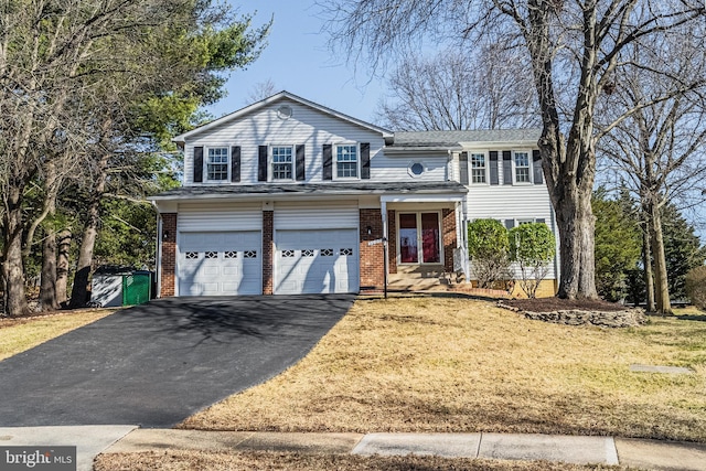 view of front of home with aphalt driveway, brick siding, a garage, and a front lawn