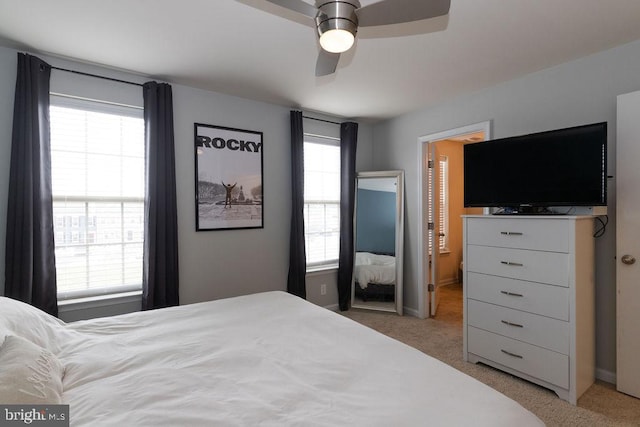 bedroom with light carpet and ceiling fan