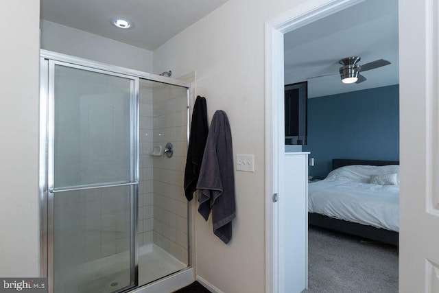 ensuite bathroom with ceiling fan, a shower stall, and ensuite bathroom