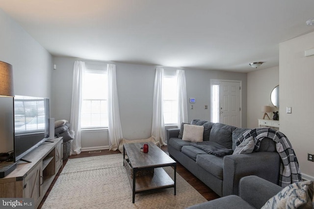 living room with wood finished floors and baseboards