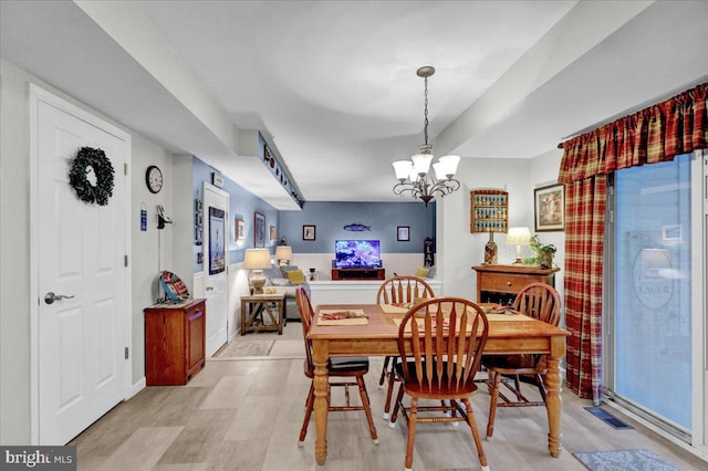 dining space featuring a chandelier and visible vents