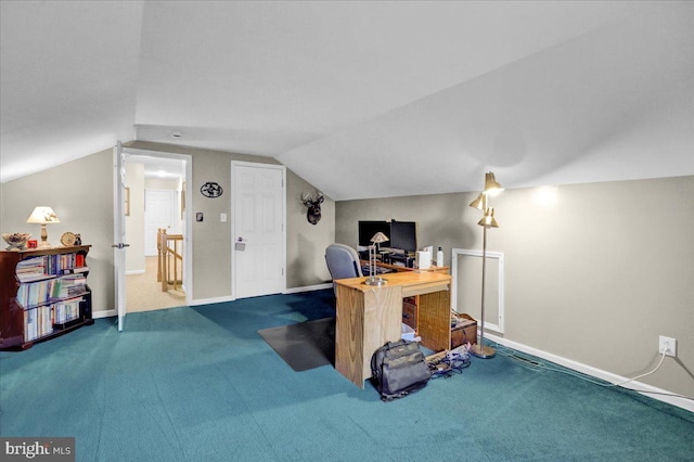 carpeted office featuring lofted ceiling and baseboards