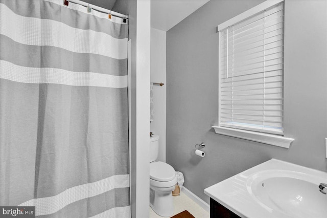 full bath with baseboards, vanity, and toilet