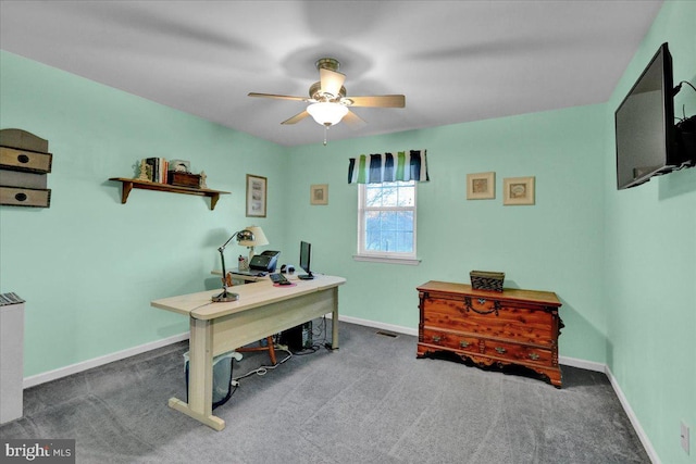 carpeted office space featuring ceiling fan, visible vents, and baseboards