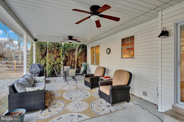 view of patio / terrace featuring outdoor dining area, an outdoor hangout area, and a ceiling fan