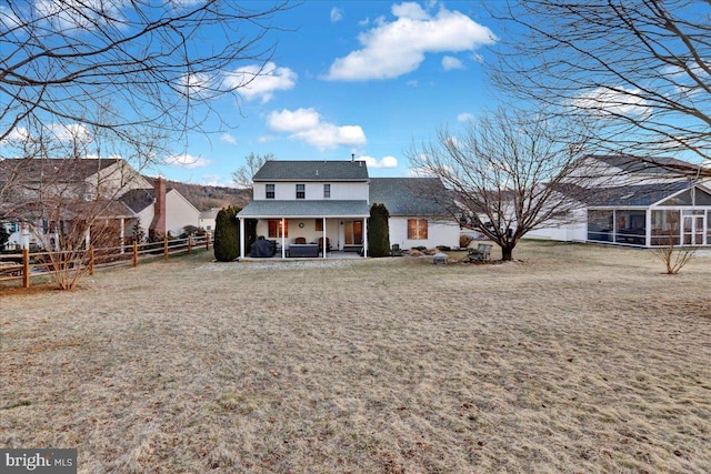 back of house with a patio area, a sunroom, a fenced backyard, and a yard