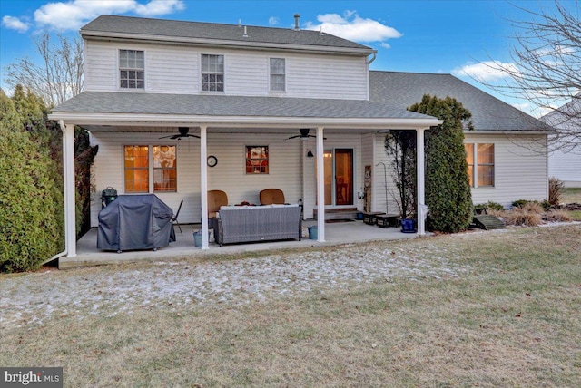 exterior space with roof with shingles, a patio, outdoor lounge area, a lawn, and a ceiling fan