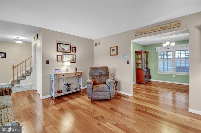 sitting room featuring stairs, wood finished floors, visible vents, and baseboards