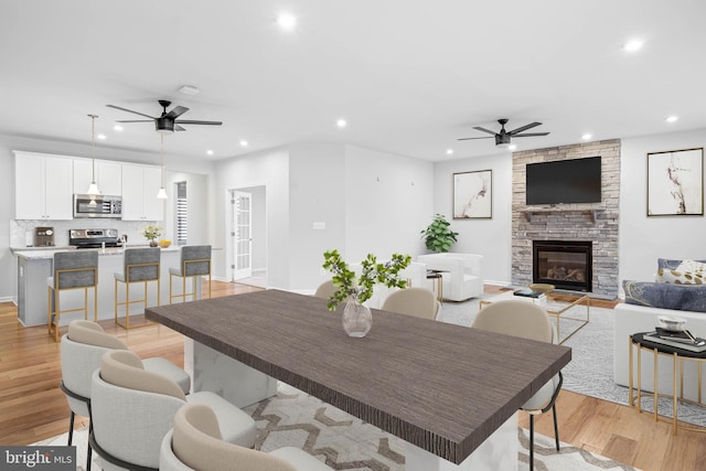 dining area featuring recessed lighting, ceiling fan, and light wood finished floors