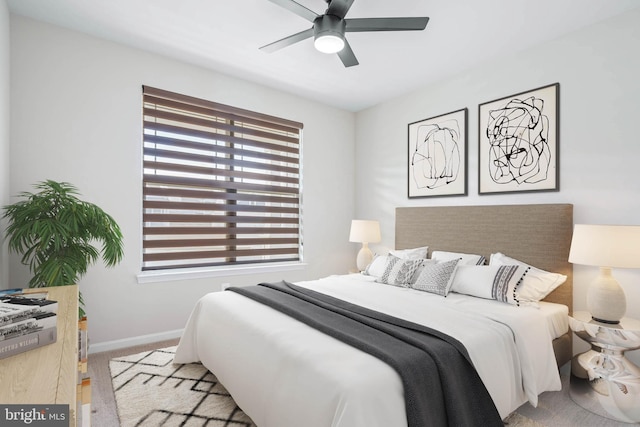 bedroom with a ceiling fan and baseboards