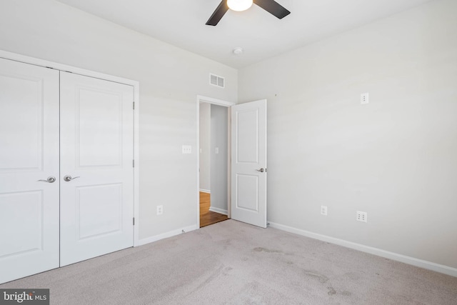 unfurnished bedroom featuring ceiling fan, a closet, baseboards, and carpet flooring