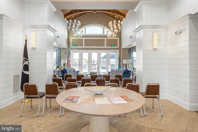 dining room with high vaulted ceiling, wood finished floors, visible vents, beamed ceiling, and an inviting chandelier