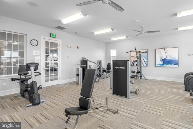 gym with light carpet, baseboards, and a ceiling fan