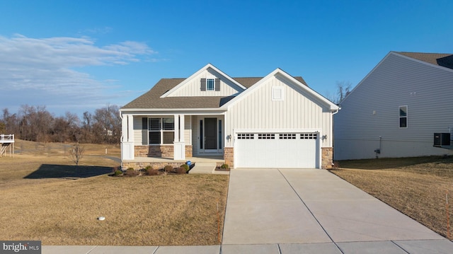 view of front of home featuring driveway, board and batten siding, and a front yard